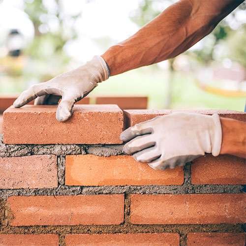 Worker laying bricks
